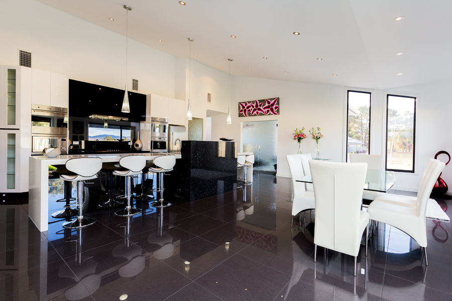 Modern kitchen with white walls and dark tiling