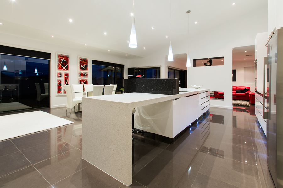Modern kitchen with white walls and dark tiling